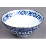 A Chinese blue and white bowl, the body with lotus blossoms and scrolls of ocean waves, six