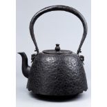 Japanese large tetsubin iron kettle, one side carved "KOSHIKAN" the other side with a logo of