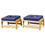 Pair of Modern ottomans, each having a blue upholstered cushion, above a sliding tray top executed