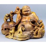 A hardstone (Tianhuang) carving of Buddha Maitreya, a seated figure surrounded by seven children