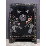 A Chinese black lacquer cabinet, of dual-door panel and gilded lock, overall painted with peony