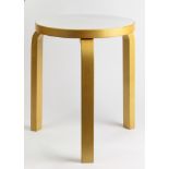 An Alvar Aalto for Artek stool, having a circular white enameled seat, and rising on three