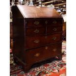 George III slant front desk circa 1800, having a quartersawn oak marquetry decorated fall front,
