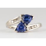 Tanzanite, diamond, 14k white gold ring Featuring (2) triangular-cut tanzanites, weighing a total of