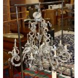 A custom silvered chandelier, having eight lights continuing to the acanthus decorated central