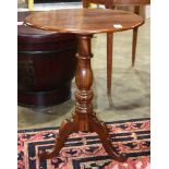 American federal style mahogany candlestand, having an oval single board top and rising on a