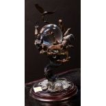 Conservation International Guardians of the World crystal ball, having a patinated metal body with