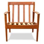 A Danish Modern teak arm chair, attributed to Grete Jalk, having a slatted back, and rising on