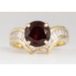 Garnet, diamond, 14K yellow gold ring Featuring (1) round-cut garnet, weighing approximately 3.45