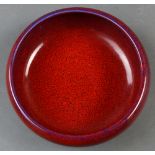 A Chinese copper red ceramic bowl, with recessed base and overall applied purple flare, size: 8"w