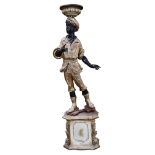 A Venetian polychrome decorated blackamoor figure circa 1900, depicting a male with a head dress,