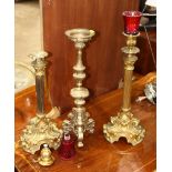 (lot of 3) Rococo style gilt candle prickets, two having a columnar form, the other having a