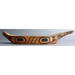 A Pacific Northwest Coast Native American canoe-form cedar feasting bowl, polychrome decorated, 18.