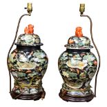 (lot of 2) A pair of Chinese lidded lamp vases, the black ground enameled with mandarin ducks and