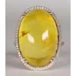 Beryl, diamond, 18k white gold ring Featuring (1) oval-cut gold beryl cabochon, measuring