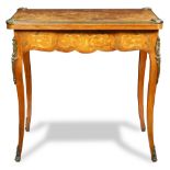 A Louis XV style inlaid games table, having a hinged top above cabriole legs terminating on