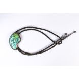 Turquoise, silver bolo tie Featuring (1) irregular turquoise cabochon, measuring approximately 66