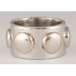 18k white gold ring The 18k white gold raised "dot" band, measures approximately 12.5 mm in width,