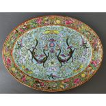 A turquoise Ground Chinese Famille-rose dish, depicting a pair of dragons with a chrysanthemum in