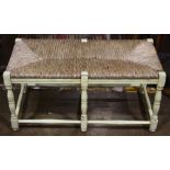 French Provincial style bench, having a rush seat above a paint decorated frame, 18"h x 37"w x 18"d