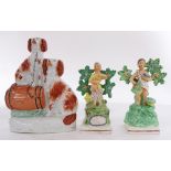 (lot of 3) Staffordshire figural sculptures, one depicting a pair of spaniels, the others of young