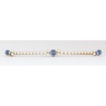 Sapphire, seed pearl, 14k yellow gold bar brooch Featuring (3) round-cut sapphires, weighing a total