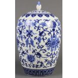 A Chinese blue and white lidded jar, of an ovoid shape and decorated with peony scroll bearing two