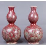 (lot of 2) A pair of Chinese "double-gourd" copper red glazed vases, each covered overall with a