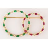 Emerald, ruby, diamond, 18K yellow gold brooch Featuring (12) marquise-cut emeralds, weighing a