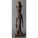 A Papua New Guinea mysteriously truncated figure, having stylized facial feaures, the abstract