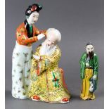 (lot of 2) Two Chinese porcelain figures, one depicting lady and a seated old man, the other a