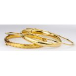 (Lot of 4) 14k yellow gold bracelets Including 1) engraved and textured, 14k yellow gold, hinged