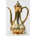 A Tiffany and Co gilt sterling coffee pot in the Islamic Taste, circa 1887, the ribbed bottle form