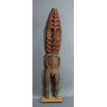 A Papua New Guinea standing figure, probably authentic, with abstract, repetitive layers surrounding