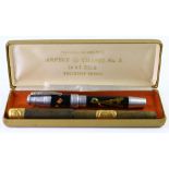 (lot of 2) Two fountain pens: a gold inlaid pen 5.5"l together with a Parisian souvenir white