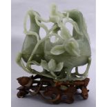 A Chinese jade carving of two conjoined duck-form boxes and lotuses, together with a carved wood