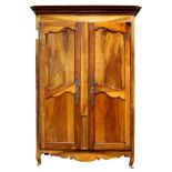 A Louis XV style walnut armoire, the molded crown over twin paneled doors centering a quarter fluted