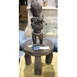 Tabwa style African stool, with a maternity figure on the top and rising on three legs, 25"h,