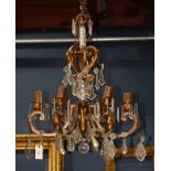 Continental crystal and patinated metal chandelier, having six arms, each with faceted crystal