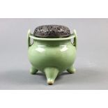 A Chinses Longquan celadon incense burner, a tripod censer with a metal lid with floral decorative