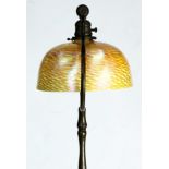 A Tiffany Studios New York damascene and patinated bronze floor lamp, the iridescent 10"w shade with