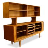 A Danish Modern teak credenza, the superstructure having two sliding glass doors opening to a