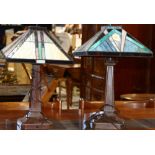 Pair of Arts and Crafts style leaded glass table lamps, each having a geometric decorated shade