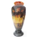 A French three color cameo glass vase, of urn form, depicting a naturalistic scene with trees in the