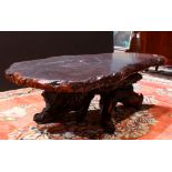 Redwood slab low table, having a free edge top above the branch form base, 16.5"h x 50"w x 29"d