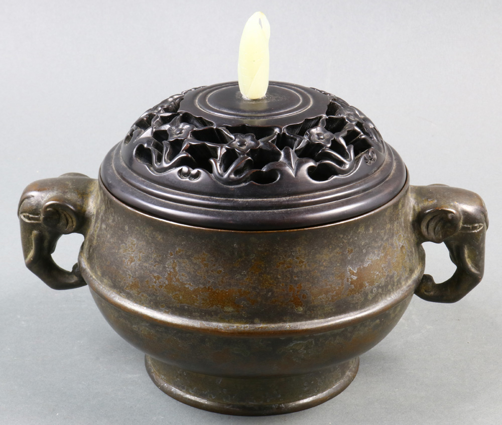 A Chinese Bronze Lidded Censer, of bombe shape and flanked by a pair of elephant handles, a six-