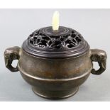 A Chinese Bronze Lidded Censer, of bombe shape and flanked by a pair of elephant handles, a six-
