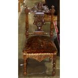 Italian Renaissance style salon chair, having a carved back surmounted by the figural crest, and