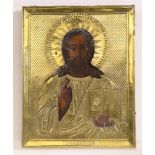 A Russian gilt brass oklad icon of Jesus the Pantocrator, holding the book, delivering a blessing