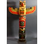 A Pacific Northwest American Indian style totem pole, late 20th Century, depicting a proud raven